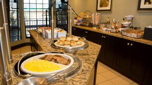 A buffet setup with various food items and a coffee station. - Suite Near Pikes National Forest | Outdoor Pool (Colorado Springs)