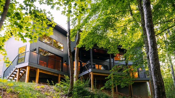 A modern two-story building with a balcony and a staircase.