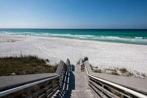 A wooden staircase leading to a beach with a clear view of the ocean. - 30A Hideaway. Walk/ride to beach. Bikes included! (Santa Rosa Beach)