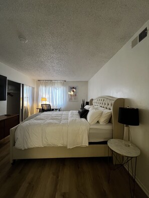 Relax in comfort with a large bed and a cozy reading nook.