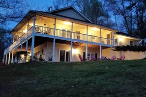 Enjoy outdoor seating on the front porch with a view of the surrounding landscape.