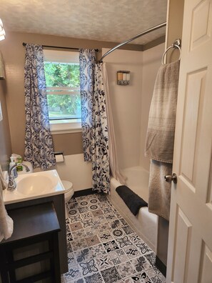 Combined shower/tub, hair dryer, towels, soap