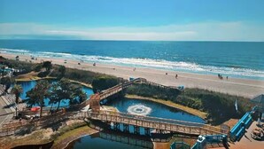 A coastal area with a beach, a water park, and a bridge. - Retreat by the Sea (Myrtle Beach)