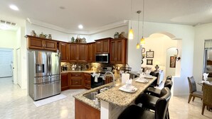 A modern kitchen with granite countertops, stainless steel appliances, and wooden cabinets. - * Waterfront home to relax, reconnect, and create unforgettable memories together! * (Rotonda West)