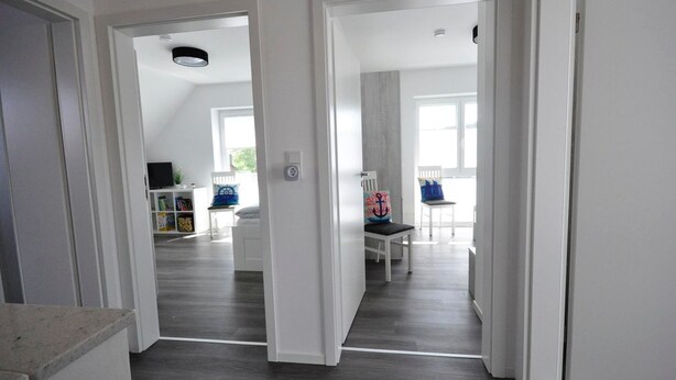 A modern interior with a hallway leading to a living area. - meinStrandhaus - Holiday home "meinStrandhaus" (Neuharlingersiel)
