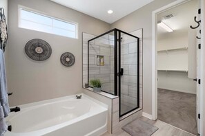 Bathtub, hair dryer, towels, shampoo
