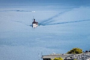 A boat on a calm body of water with a clear sky.