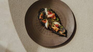 A dish on a textured plate with a geometric pattern.