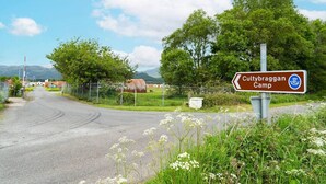 A rural road with a sign for Cultybraggan Camp. - Hut 34 at Cultybraggan Camp (Cultybraggan Camp, Comrie)