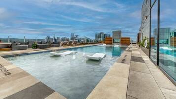 A rooftop pool, pool loungers