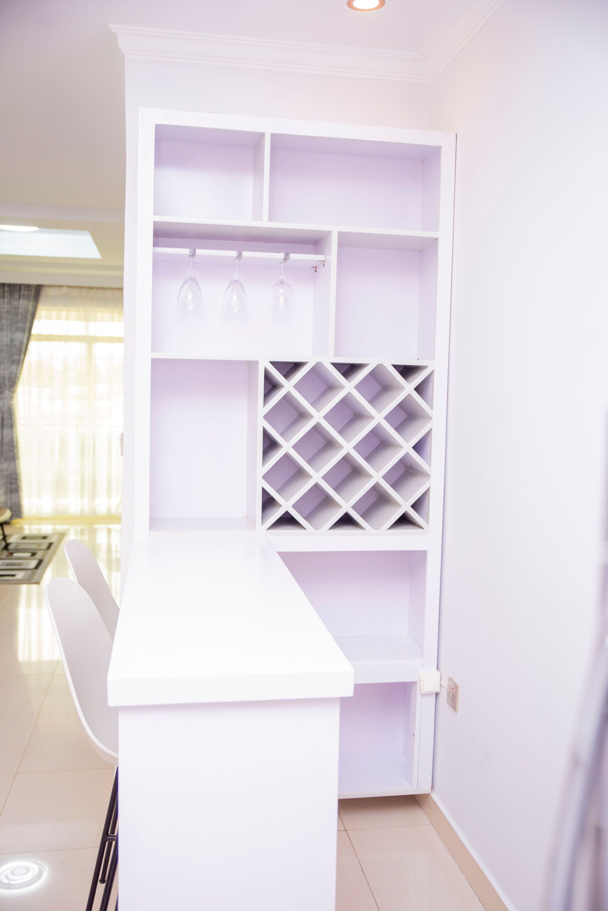 A white interior with a built-in wine rack and a bar area.