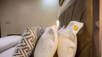 A bed with patterned pillows and a headboard.