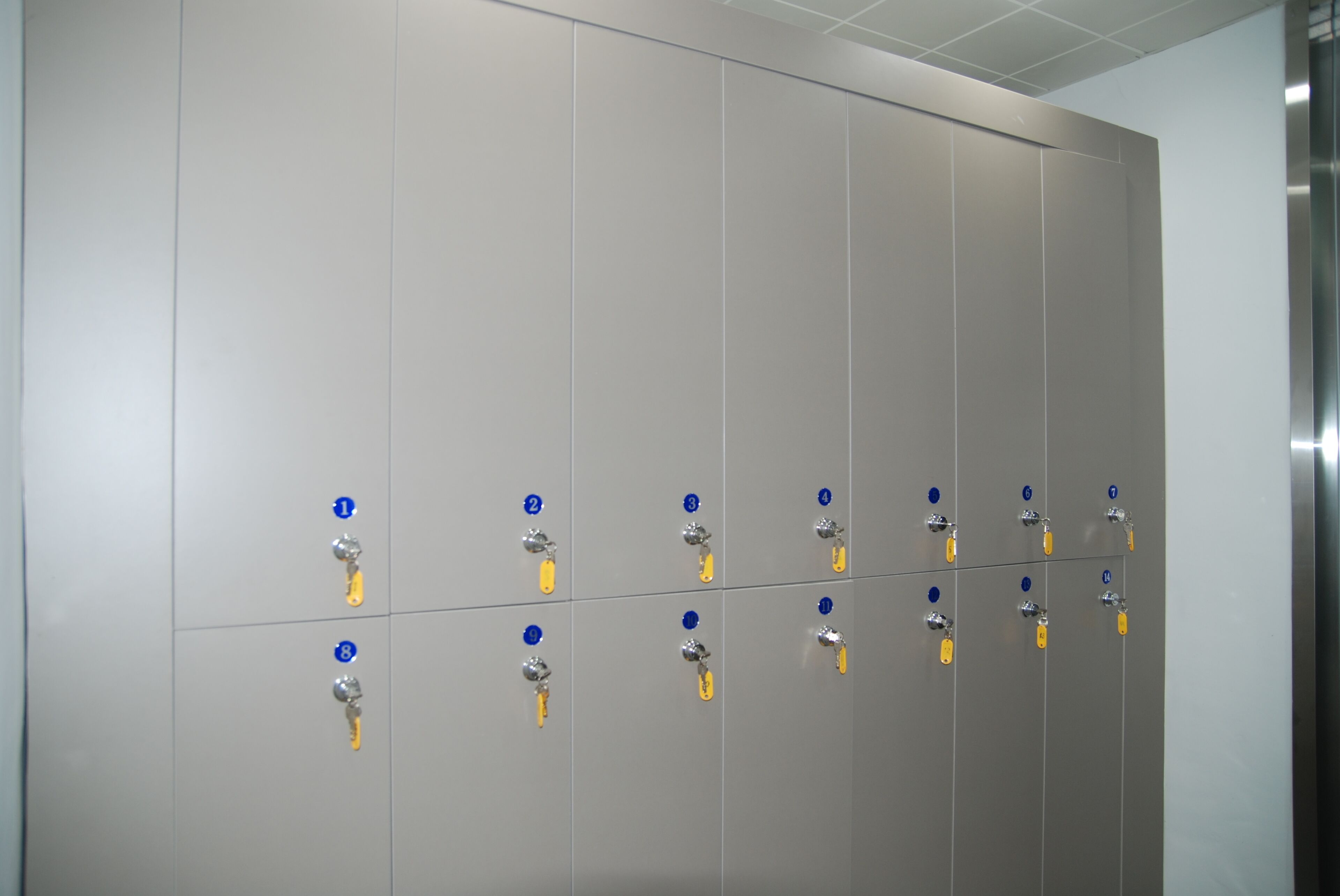 A row of lockers with numbered keys and a metallic handle.