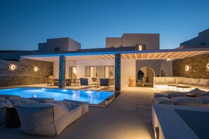 A modern outdoor pool area with lounge seating and a covered patio. - ONEIRO VILLA. ANTIPAROS AS DREAMY AS IT GETS (Antiparos)