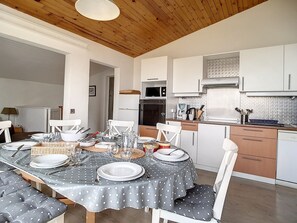 A modern kitchen with white cabinets, a microwave, and a coffee maker. - Spacious Duplex Near Slopes · 3 Bedrooms · 2 Balconies (Les Menuires)