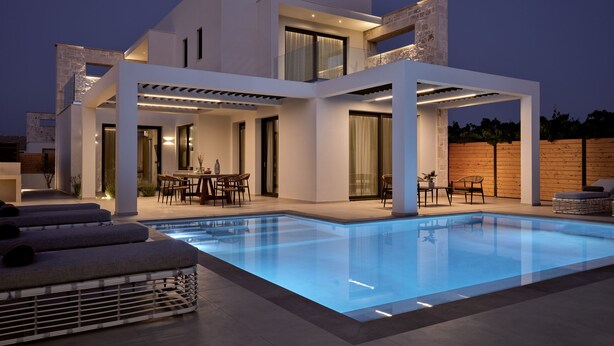 A modern two-story house with a swimming pool, outdoor seating, and a covered patio area. - Anthis Luxury Villa (Zakynthos)