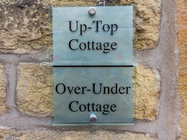 A sign with two labels: 'Up-Top Cottage' and 'Over-Under Cottage.' - Up-top Cottage (Holmfirth)
