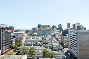 A cityscape with modern buildings, including a prominent hotel with a large sign. - 1306 The Sentinel (Cape Town)