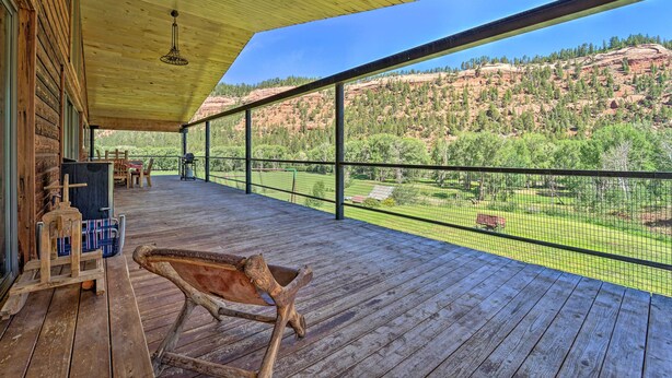 Eine Holzterrasse mit Blick auf eine gebirgige Landschaft.