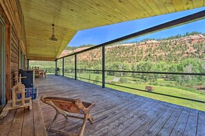 A wooden deck with a view of a mountainous landscape.