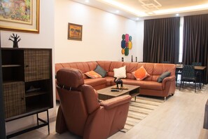 Superior Apartment | Living area | 43-inch Smart TV with satellite channels, TV - Iris Apartment (Dakar)