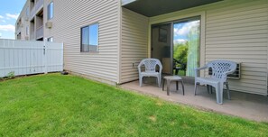 Enjoy a casual outdoor seating area with a sliding glass door leading to the interior.