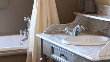 A bathroom with a sink, mirror, and shower curtain.