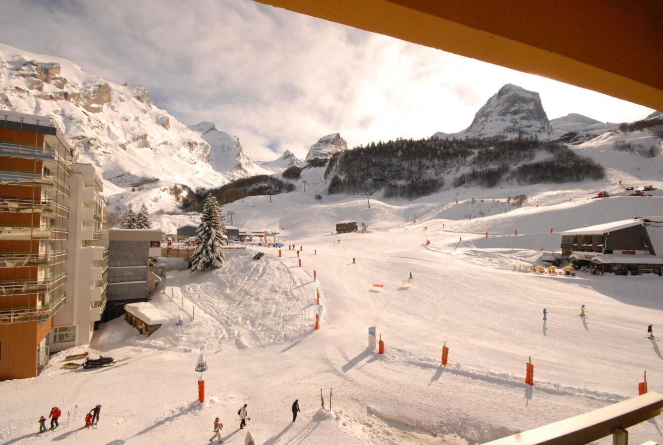 Ein Skigebiet mit Seilbahn, schneebedeckten Pisten und einem Berg im Hintergrund.
