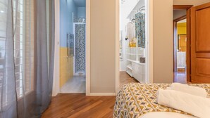 A bedroom with a bed, a walk-in closet, and a bathroom with a shower and toilet. - Kitty Apartment   to visit S. Pietro (ROMA)