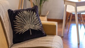 A living room with a sofa, a floor lamp, and a large potted plant. - Kitty Apartment   to visit S. Pietro (ROMA)