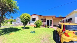 A residential property with a covered porch, a lawn, and a yellow car parked in front. - Perfect location close to beach's, town centre and the golf course (South West Rocks)