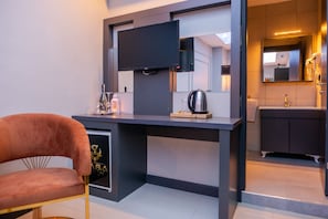 Contemporary room with a sleek desk, flat-screen TV, and comfortable chair.