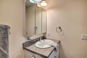 A bathroom with a granite countertop, white sink, and a large mirror. - Lakefront Alton Bay Retreat w/ Dock Near Beaches! (Alton Bay)