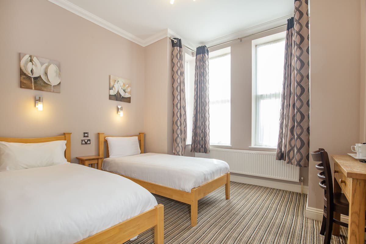 Standard Twin Room | Desk, blackout drapes, iron/ironing board, free WiFi