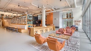 A spacious lobby with a bar area, seating arrangements, and a staircase leading to upper levels. - Sentral Union Station (Denver)