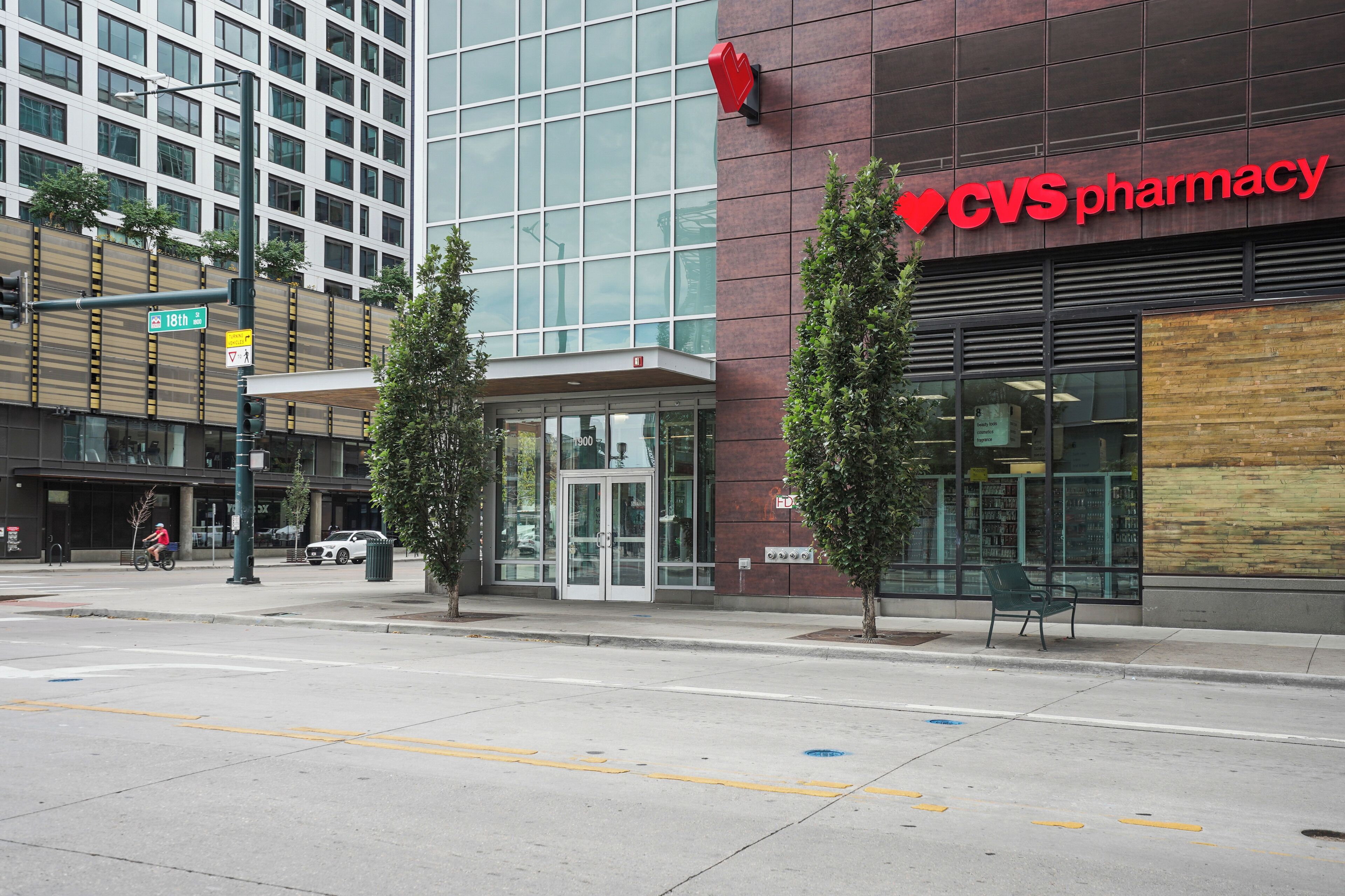 A CVS pharmacy with a glass entrance and a modern building facade.