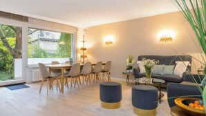 A modern living room with a dining area, a sofa, and a coffee table. - Livingroom Mathildenhöhe (Darmstadt)