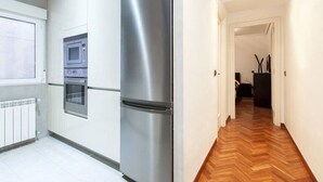 A modern kitchen with a stainless steel refrigerator, built-in oven, and microwave. - Luxury Flat in Madrid center (Madrid)
