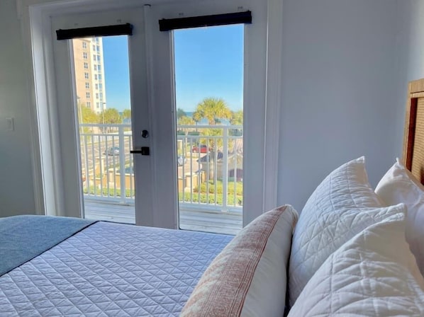 Relax in this inviting room with a large bed and sliding glass door leading to a balcony with a view.