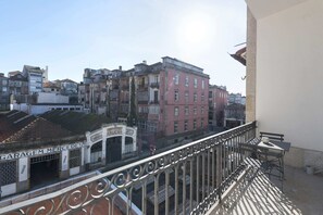 Overlooking the vibrant city streets, this balcony offers a glimpse into the local architecture.