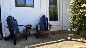 A white house with two Adirondack chairs, a potted plant, and a welcome mat outside. - Mountain Views/Studio in Montecito. 7-10 min to beach or downtown SB (Montecito)