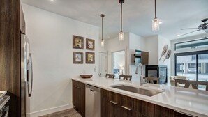 A modern kitchen with a large island, stainless steel appliances, and pendant lighting. - River West · Upscale Value, Centrally Located & Comfortable (Silverthorne)