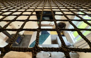 A close-up of a rope netting structure, likely part of a room's window or entrance. - The Mont-Saint-Anne Landmark (Beaupré)