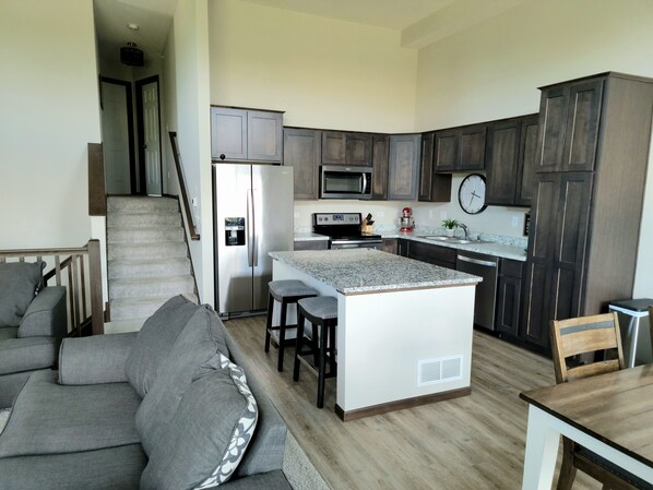 Enjoy cooking and socializing in this well-equipped kitchen with a central island and adjacent living area.