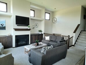 Relax in this inviting living room with a large sofa, fireplace, and flat-screen TV.