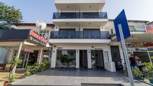 A multi-story building with a modern design, featuring a restaurant named "BUKIT" and a store named "CICEKCH." - Rooms365 (Fethiye)