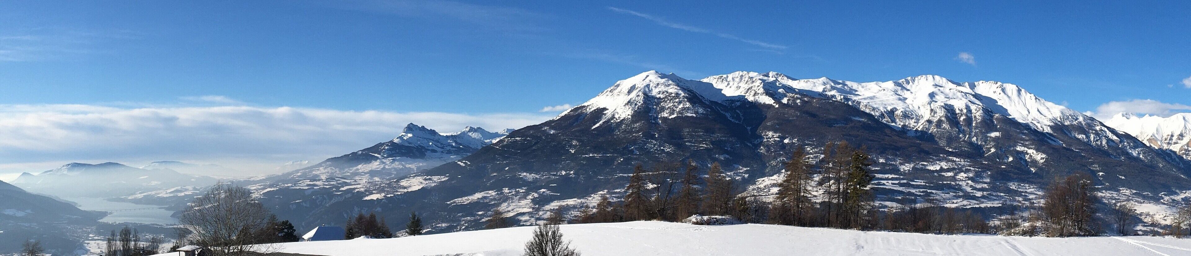 A snow-covered mountain landscape with a clear sky.