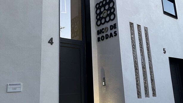 Un bâtiment avec une porte noire et une enseigne sur laquelle on peut lire « BICO DE RODAS ».
