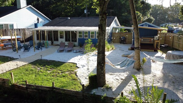 A backyard with a hammock, outdoor seating, and a pool area. - River Beach Retreat: with Tiki Bar, Fire Pit, Hot Tub & Clear Kayak (Spring Hill)