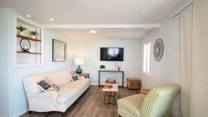 A living room with a sofa, armchair, coffee table, and TV. - #3 Just a few steps from Ocean! Incredible Views! (Carolina Beach)